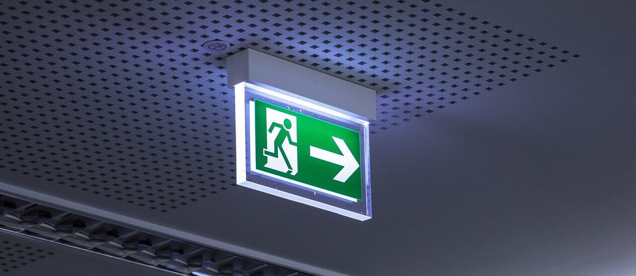 Emergency exit sign point towards a fire door